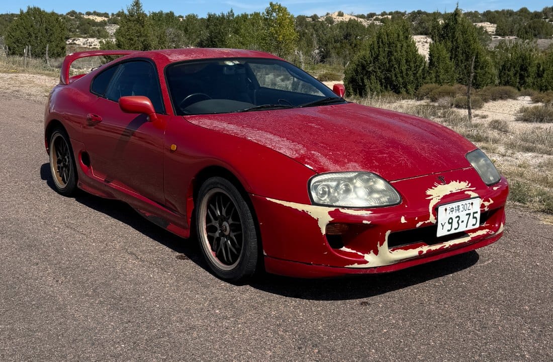 Red MKIV Supra, front three-quarter, as it sits on day 1